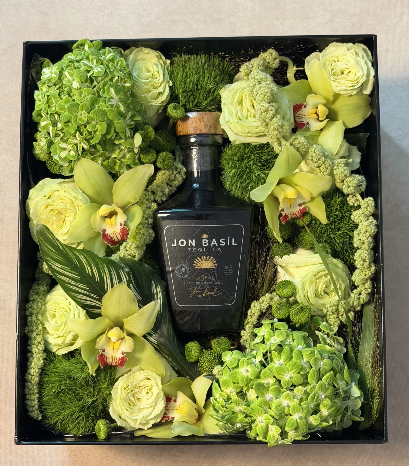 Top view of the green floral box with tequila bottle