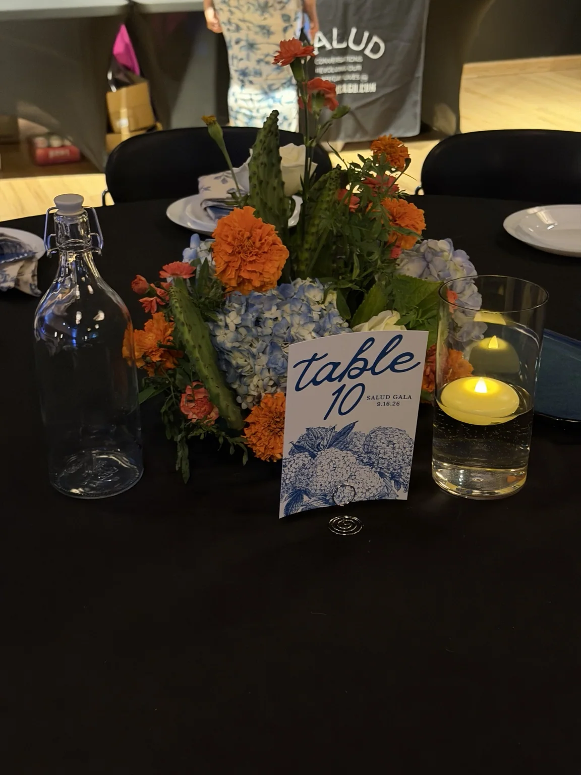 Centerpiece with table number card and candles at the event