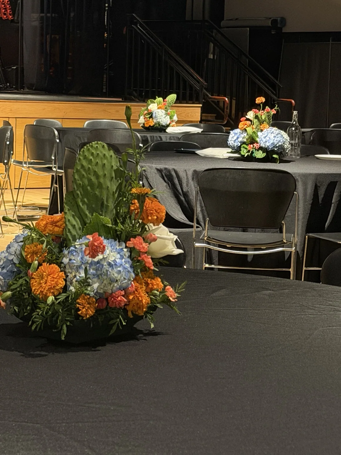 Nopal and marigold centerpiece on a table in the event hall