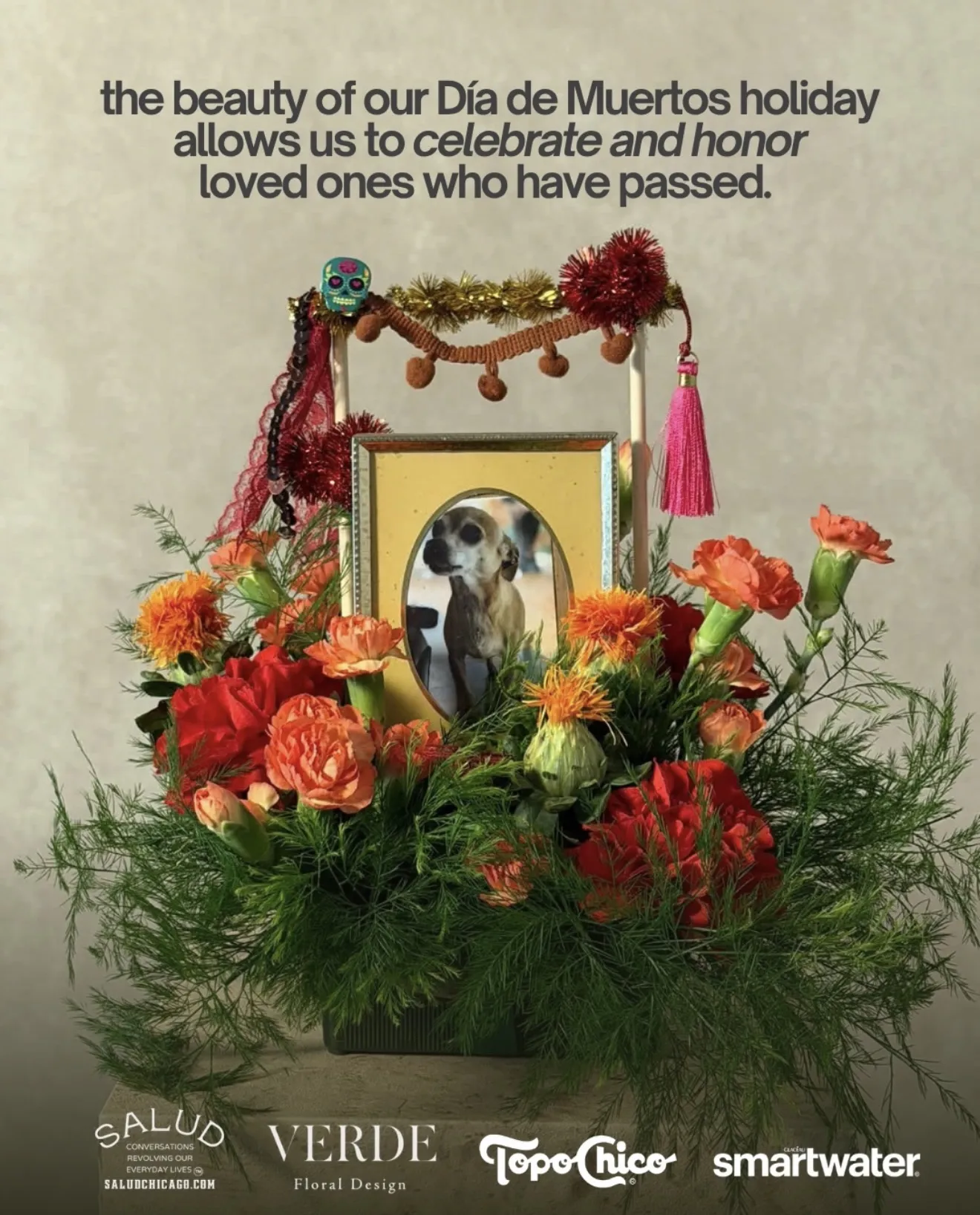 Umbral, Día de Muertos ofrenda arrangement of orange and red flowers around a framed photograph